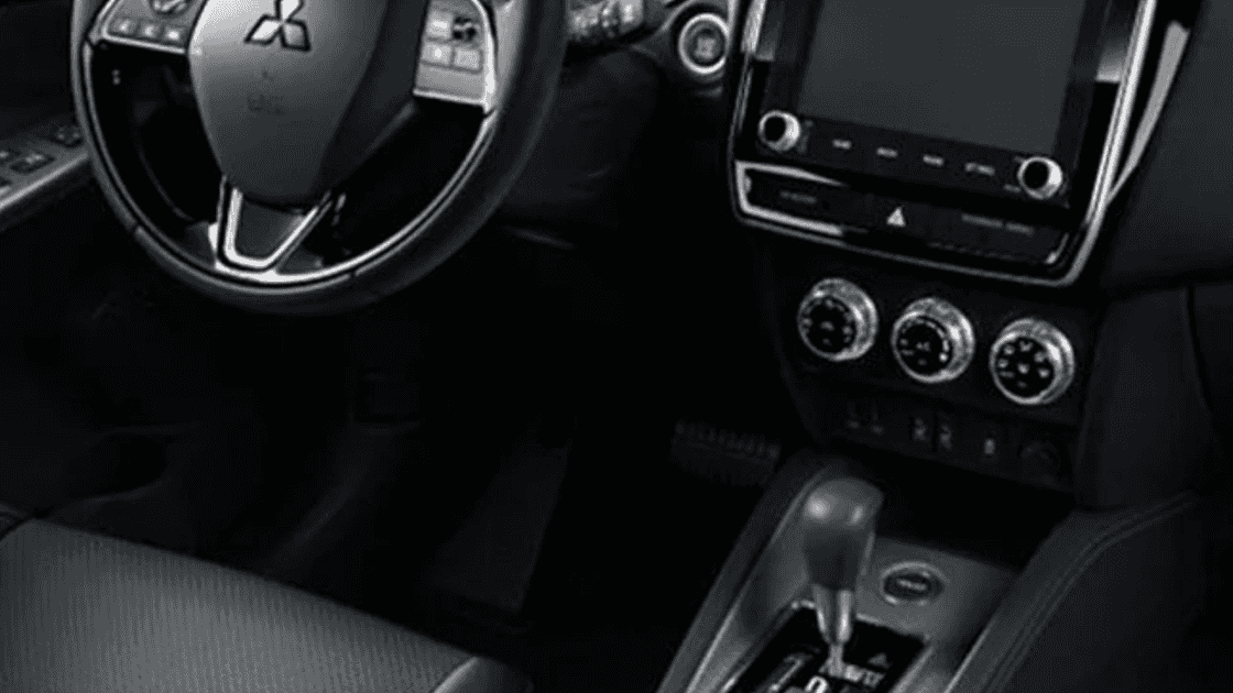 2026 Mitsubishi Outlander Sport dashboard with touchscreen, climate dials, and gear shifter