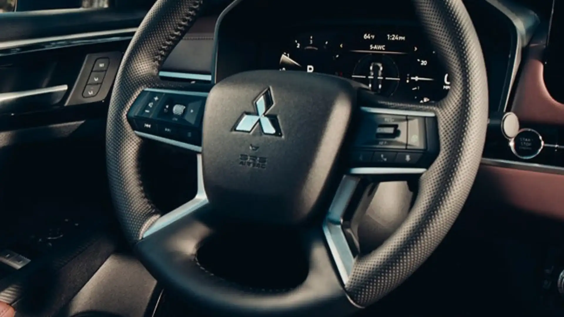 2026 Mitsubishi Outlander steering wheel and digital gauge cluster displayed in a modern cabin view.