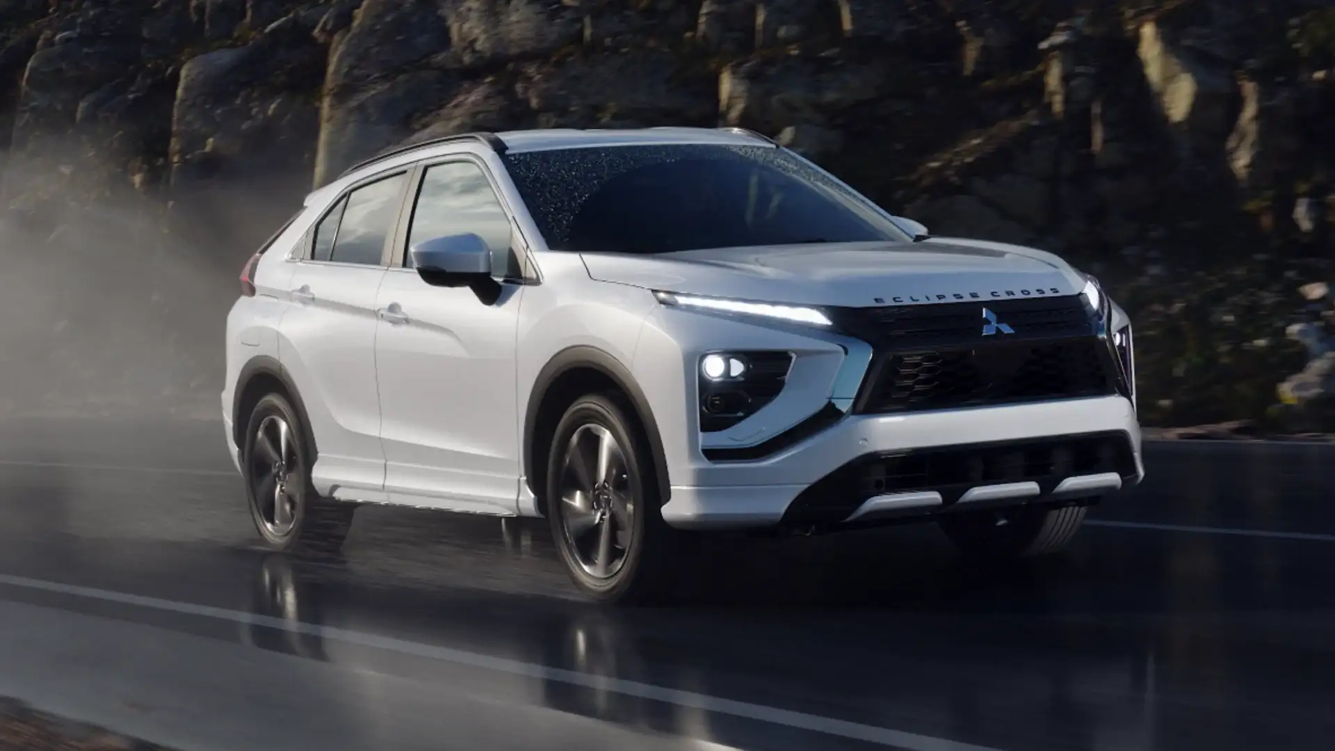 2026 Mitsubishi Eclipse Cross interior showing driver seat, steering wheel, center console, and touchscreen.