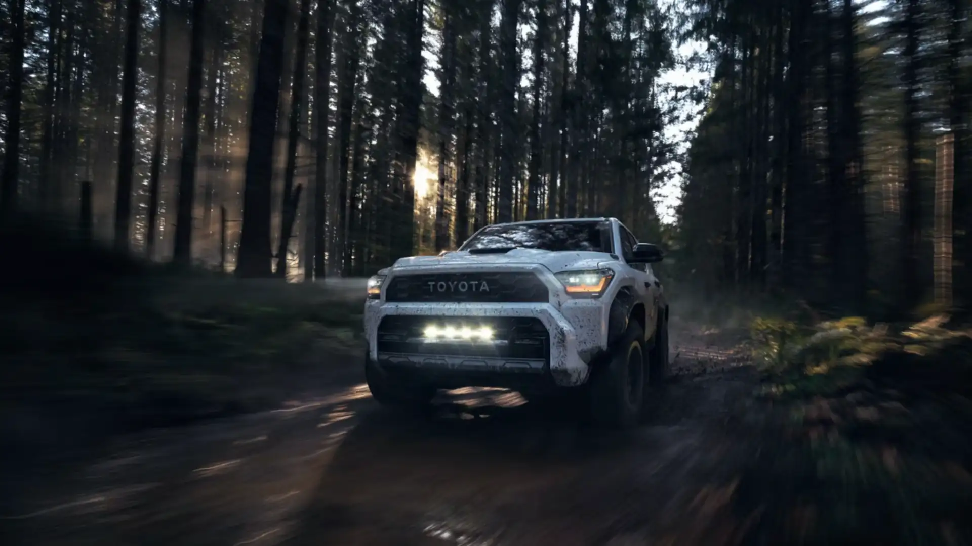 2025 Toyota 4Runner driving through a forest trail, demonstrating off-road performance and rugged SUV styling near Greencastle, PA.