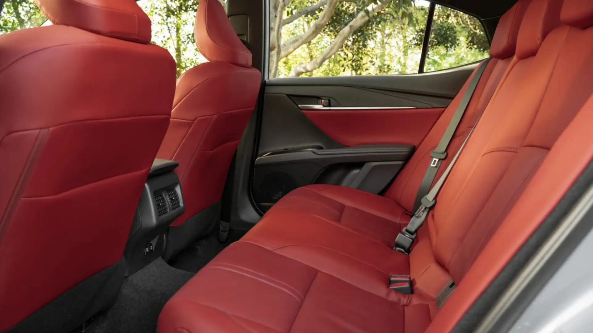 2025 Toyota Camry rear seats with red leather upholstery highlighting modern interior design and premium comfort