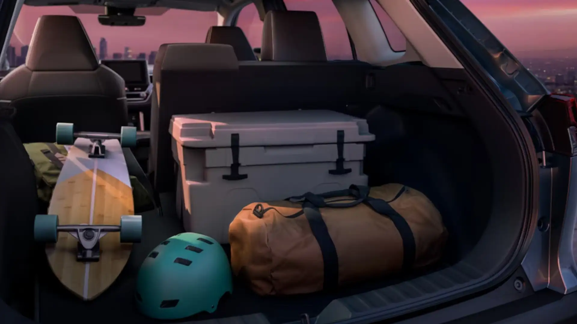 2025 Toyota Corolla Cross interior comfort and cargo space showing a spacious rear cargo area with travel gear, cooler, and outdoor equipment for daily and weekend use.