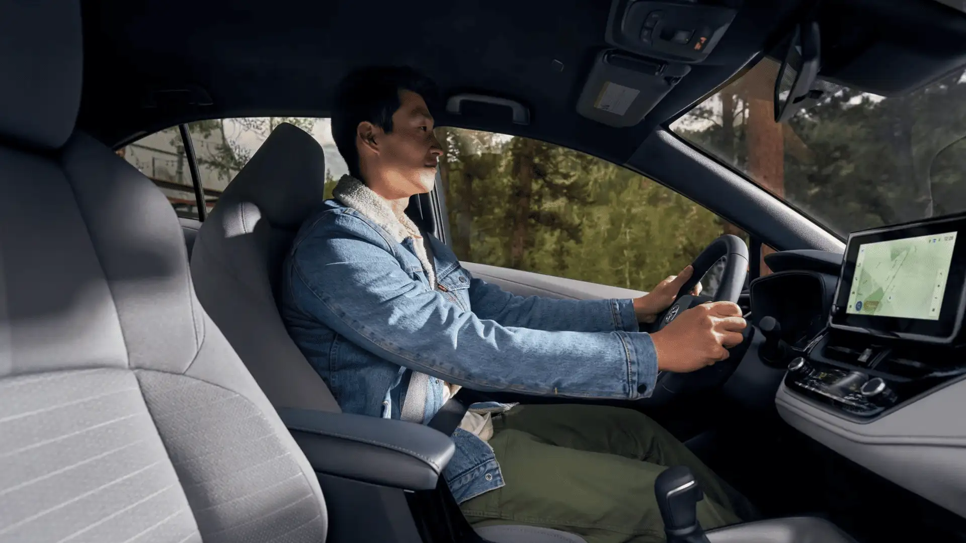 Interior cabin view of the 2025 Toyota Corolla Hybrid showing seating layout, center console controls, and driver-focused design.