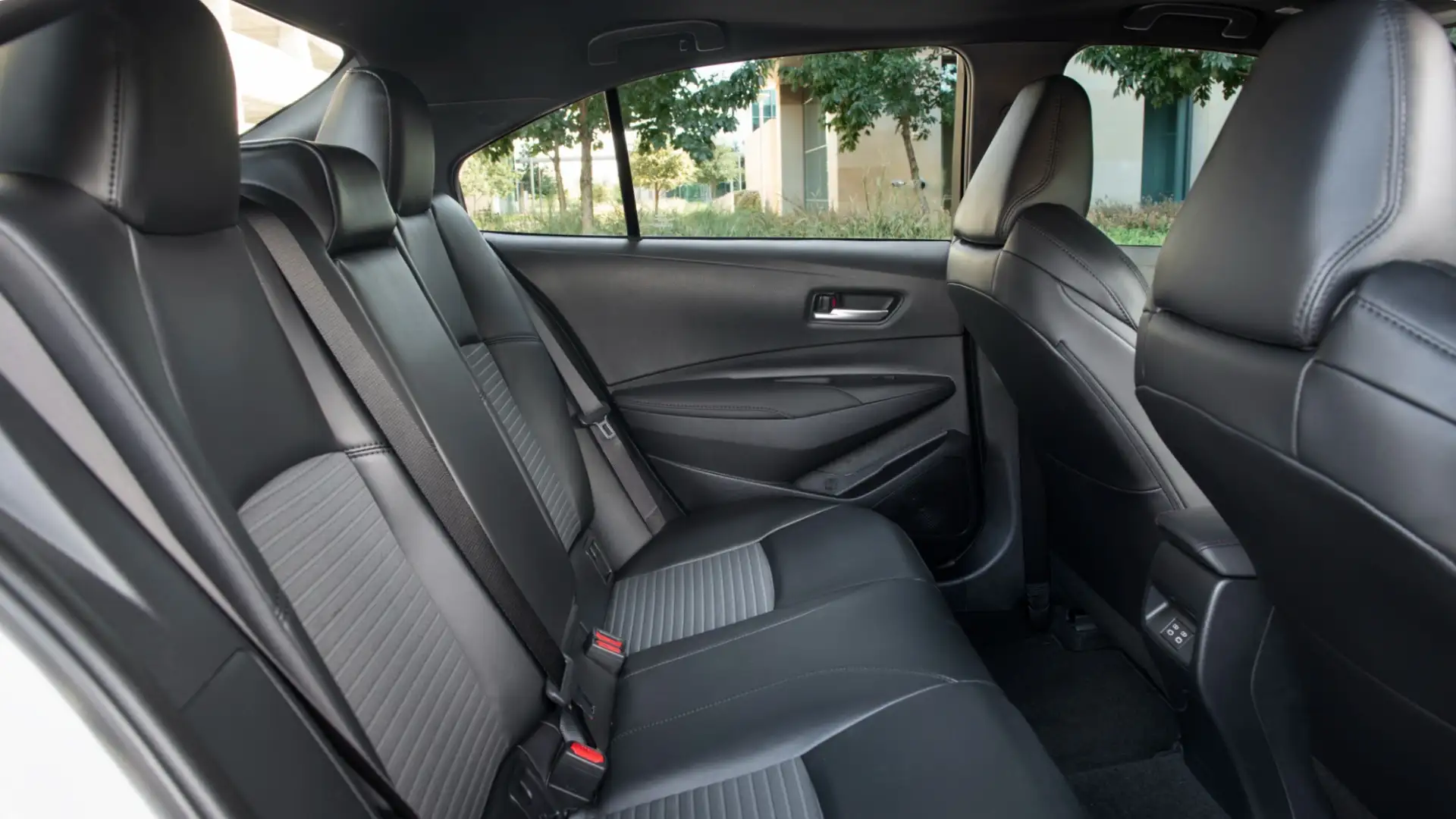 2025 Toyota Corolla interior featuring front and rear seating layout, black upholstery, and practical cabin design for everyday driving.