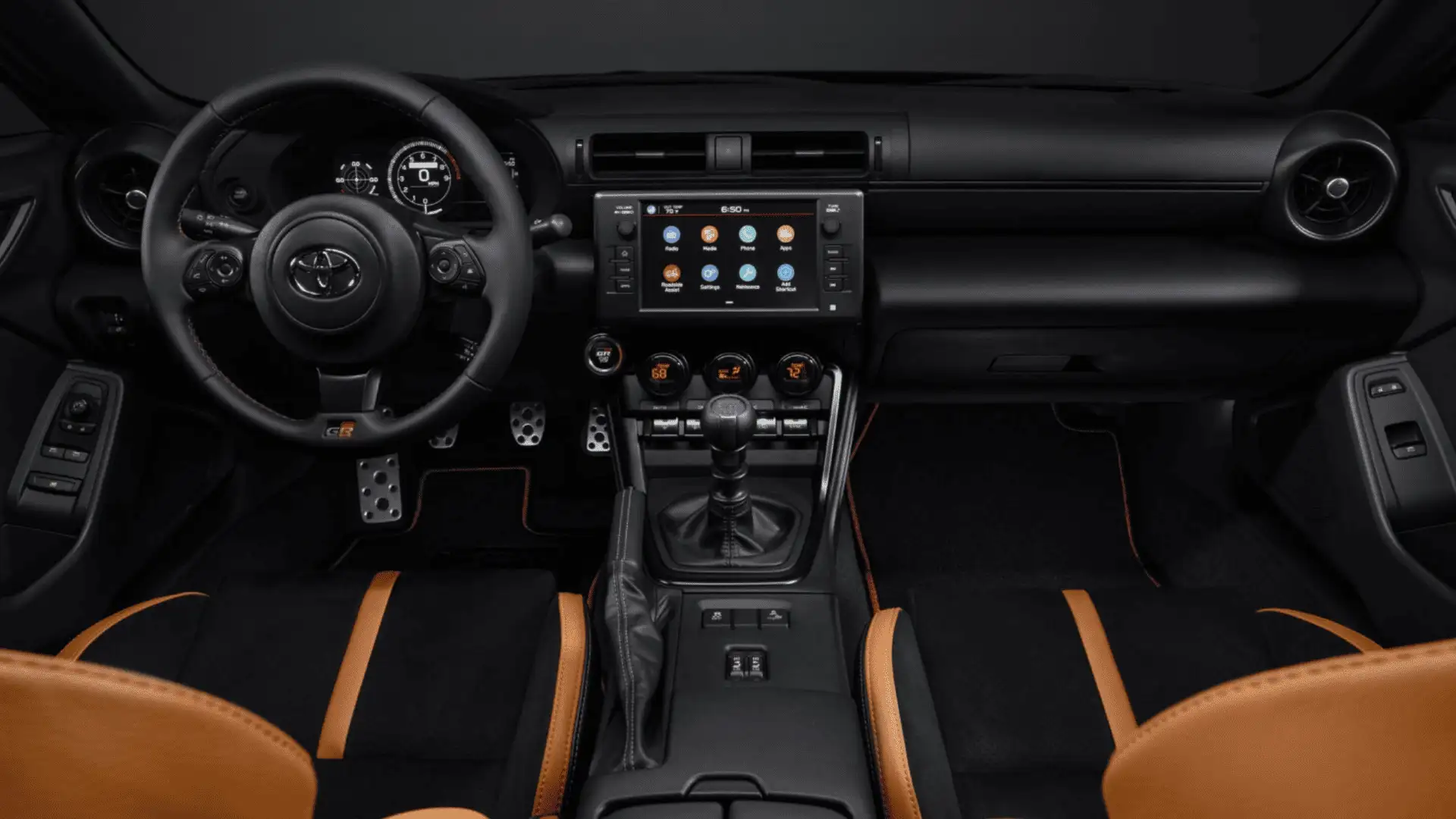 Driver-centric cockpit of the 2025 Toyota GR86 featuring sporty steering wheel, performance gauges, touchscreen display, and premium interior materials.
