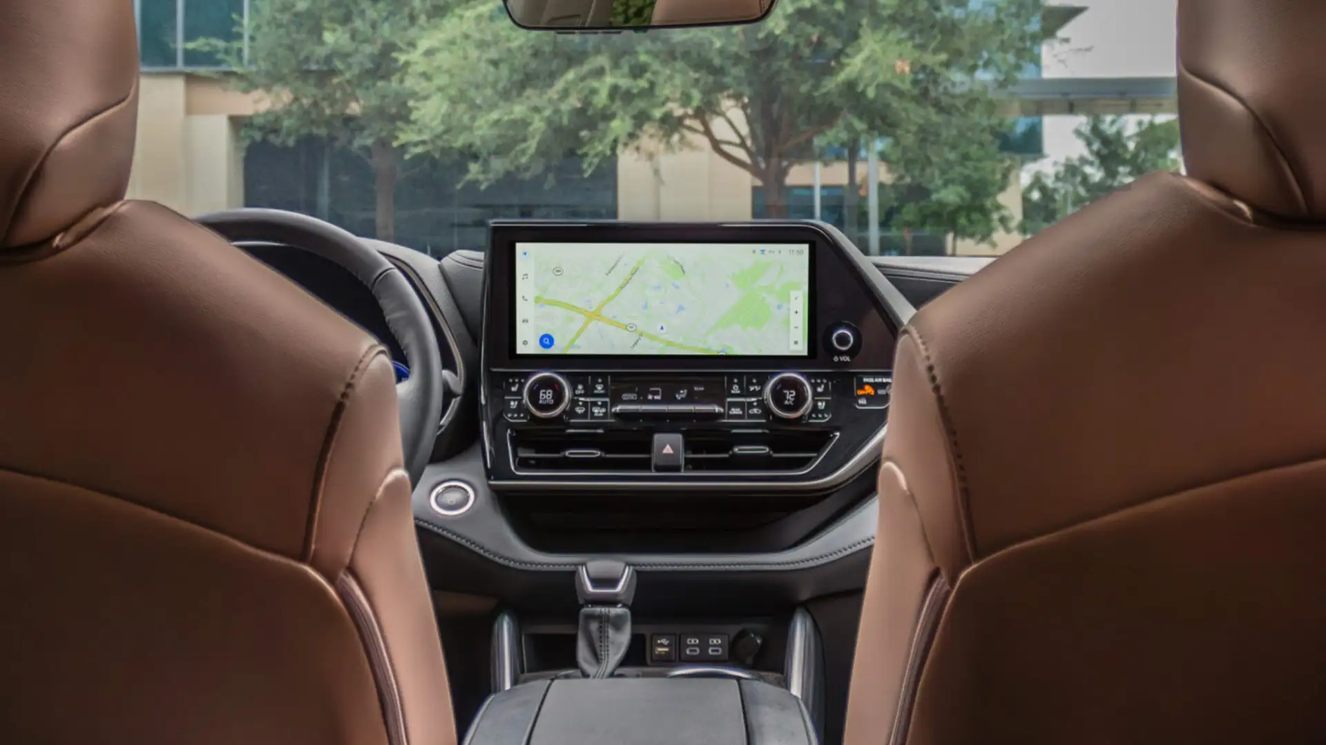 2025 Toyota Highlander Hybrid interior featuring modern dashboard layout, touchscreen infotainment system, and premium seating design