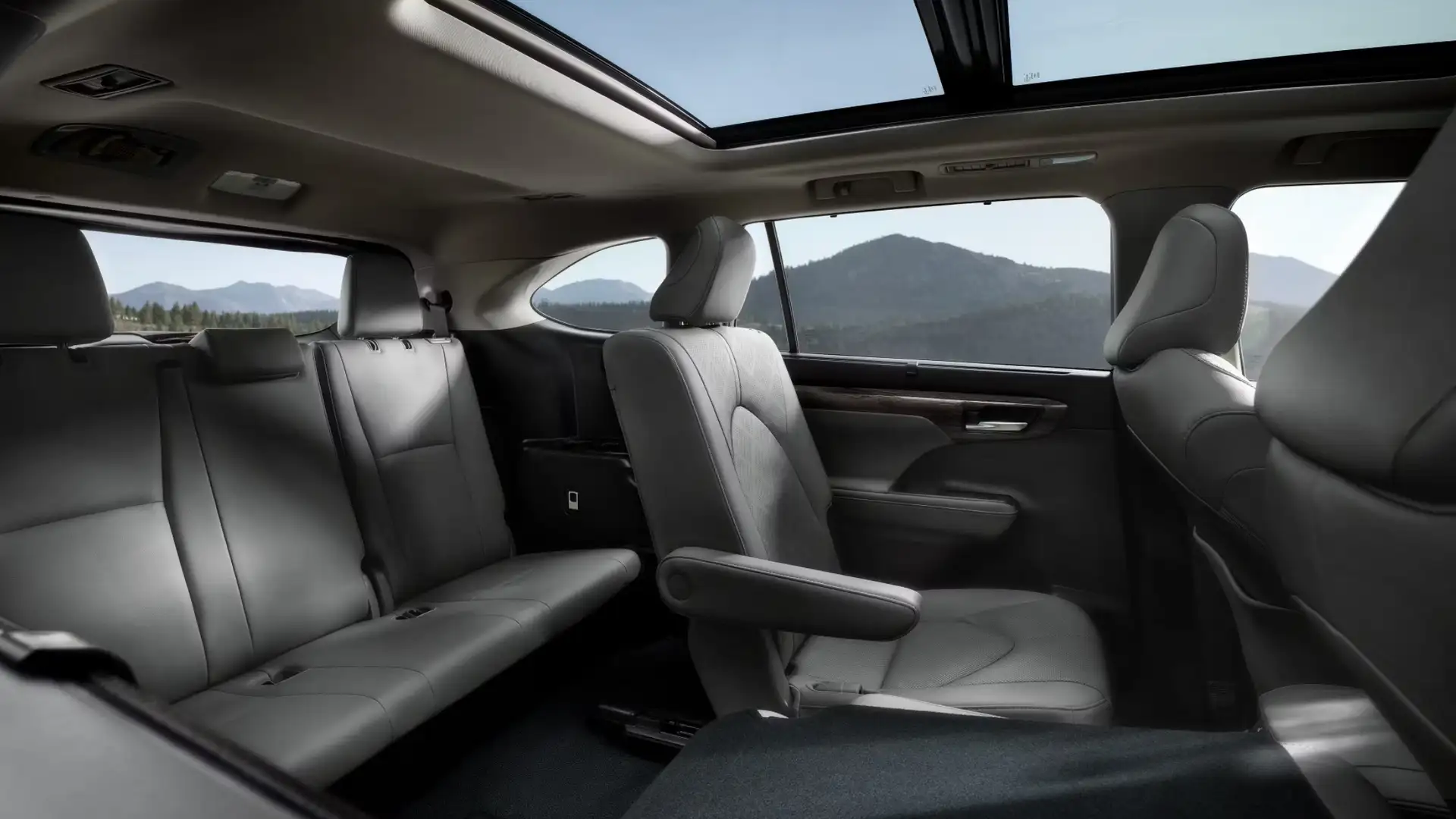 2025 Toyota Highlander interior space and advanced technology featuring second and third row seating, a panoramic sunroof, and a spacious modern SUV cabin.