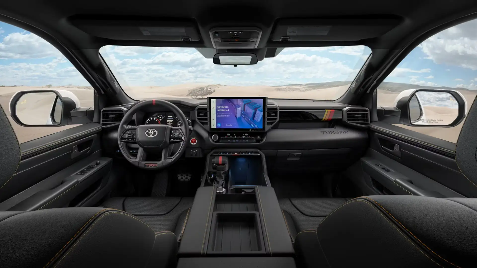 2025 Toyota Tundra interior comfort and space showing the front cabin with a wide touchscreen, leather seats, and rugged pickup truck interior design.