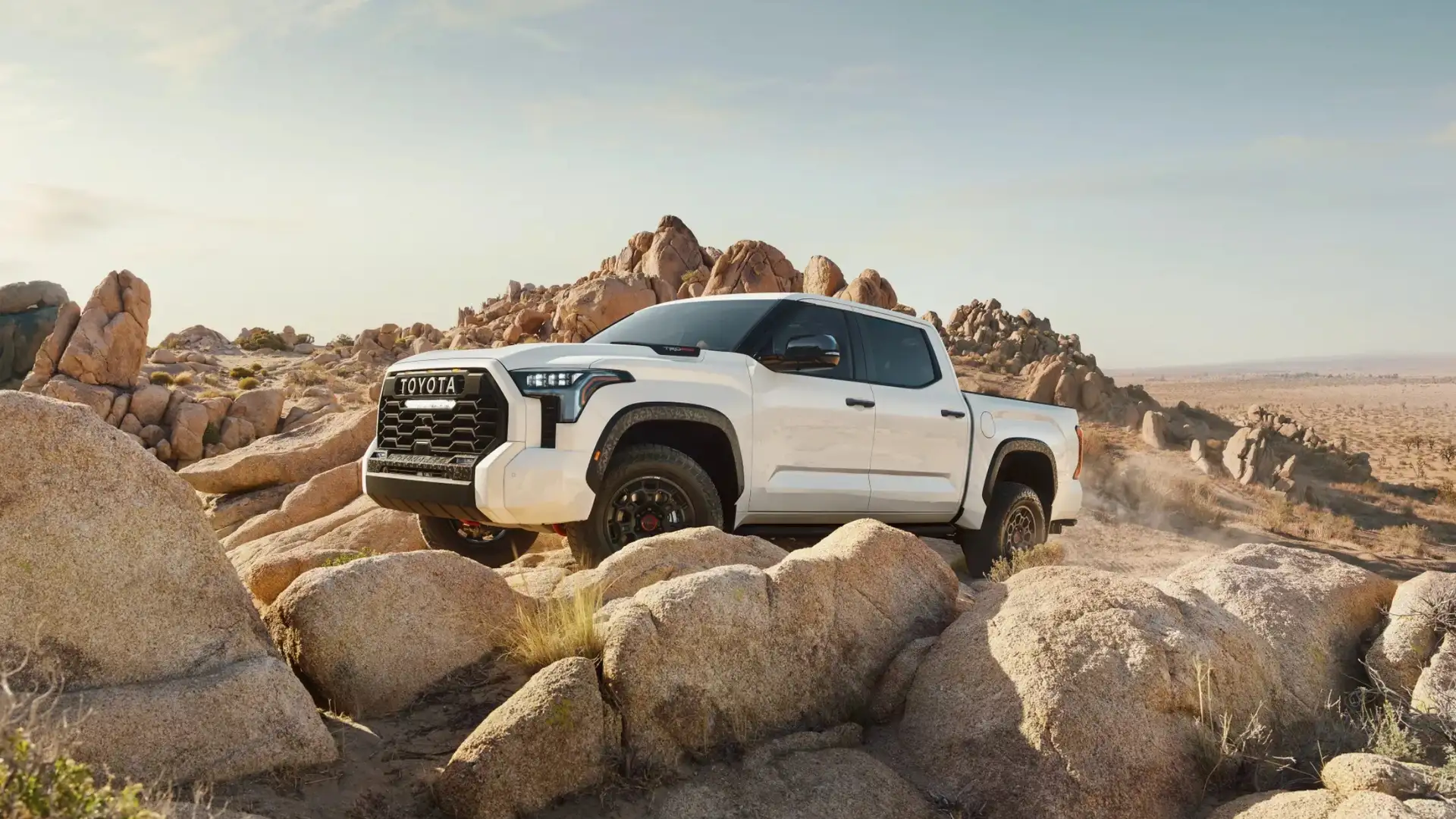 2025 Toyota Tundra parked on rocky terrain, showcasing its rugged design and off-road capability compared to other full-size trucks in Maryland.
