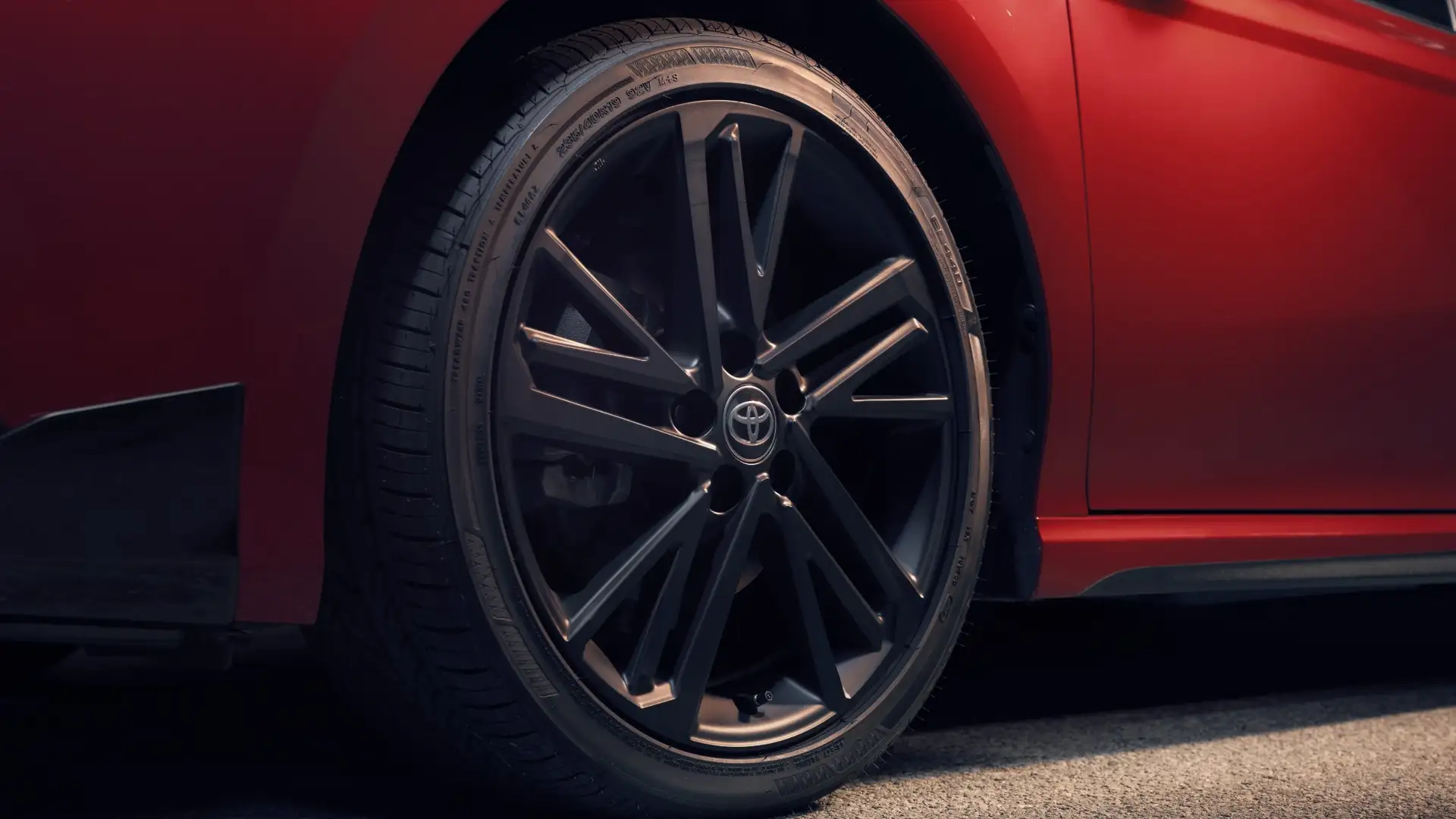 2026 Toyota Camry Nightshade Edition exterior highlighting sporty black alloy wheels, sleek body lines, and bold red paint finish.
