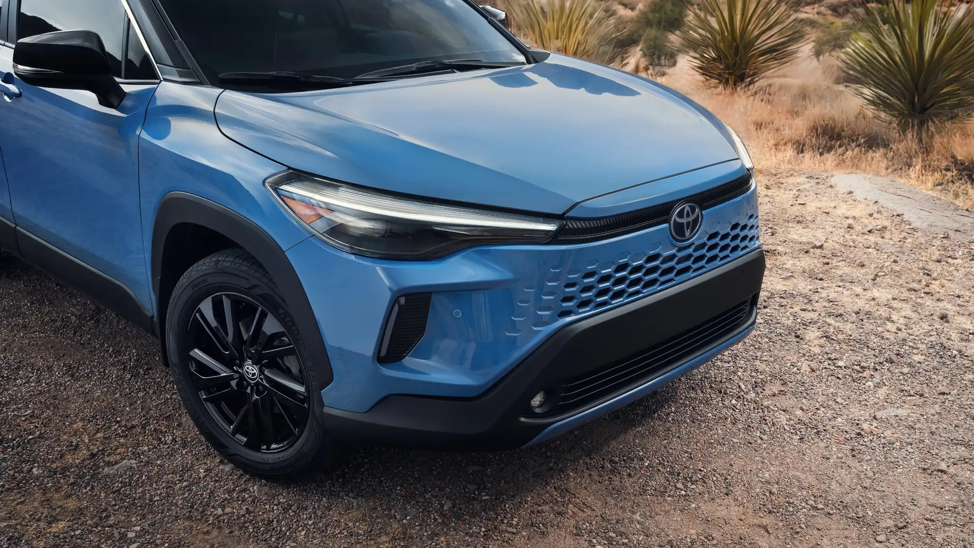 2026 Toyota Corolla Cross exterior highlighting efficient gasoline and hybrid powertrain options with a bold front grille design.