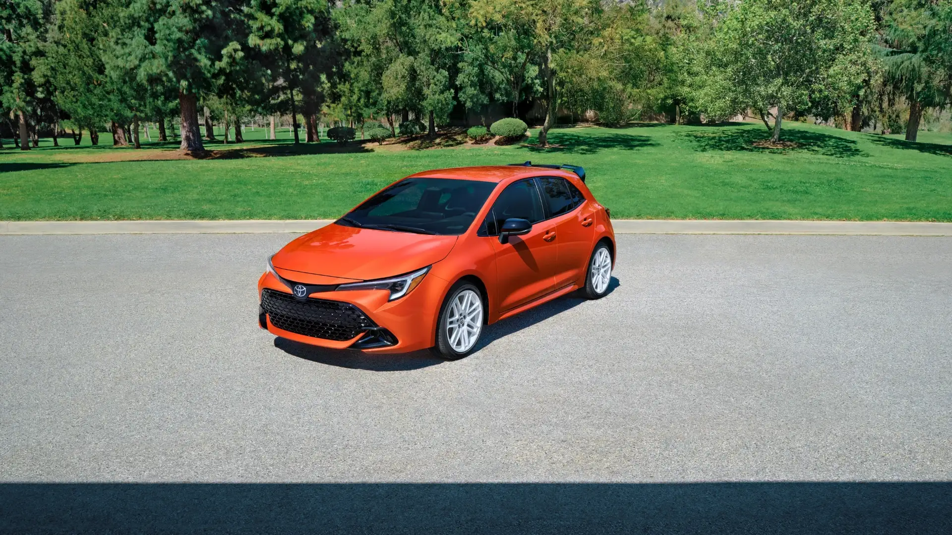 2026 Toyota Corolla Hatchback in Greencastle, PA shown in orange exterior with compact hatchback design, sporty front styling, and modern alloy wheels.