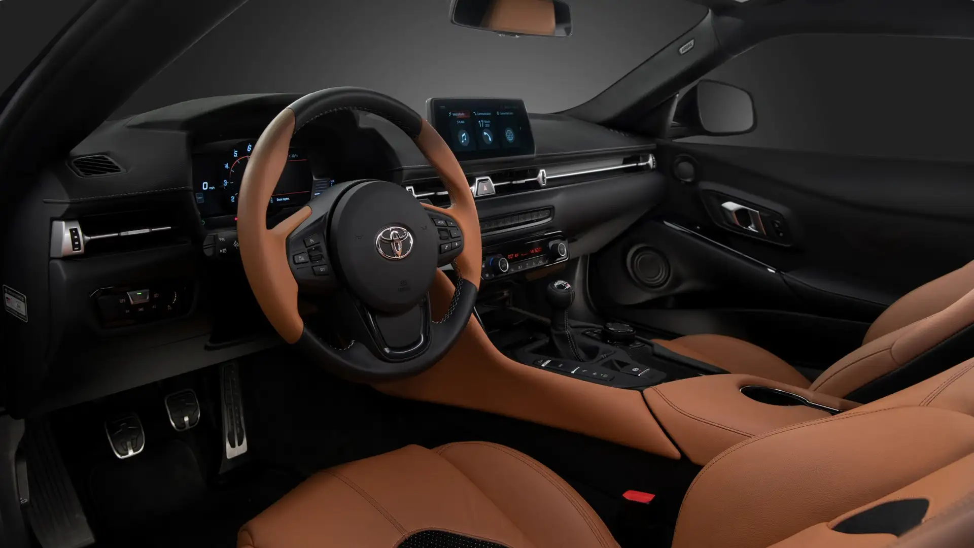 Dashboard and infotainment system of the 2026 Toyota GR Supra with touchscreen display, digital gauges, and premium audio controls.