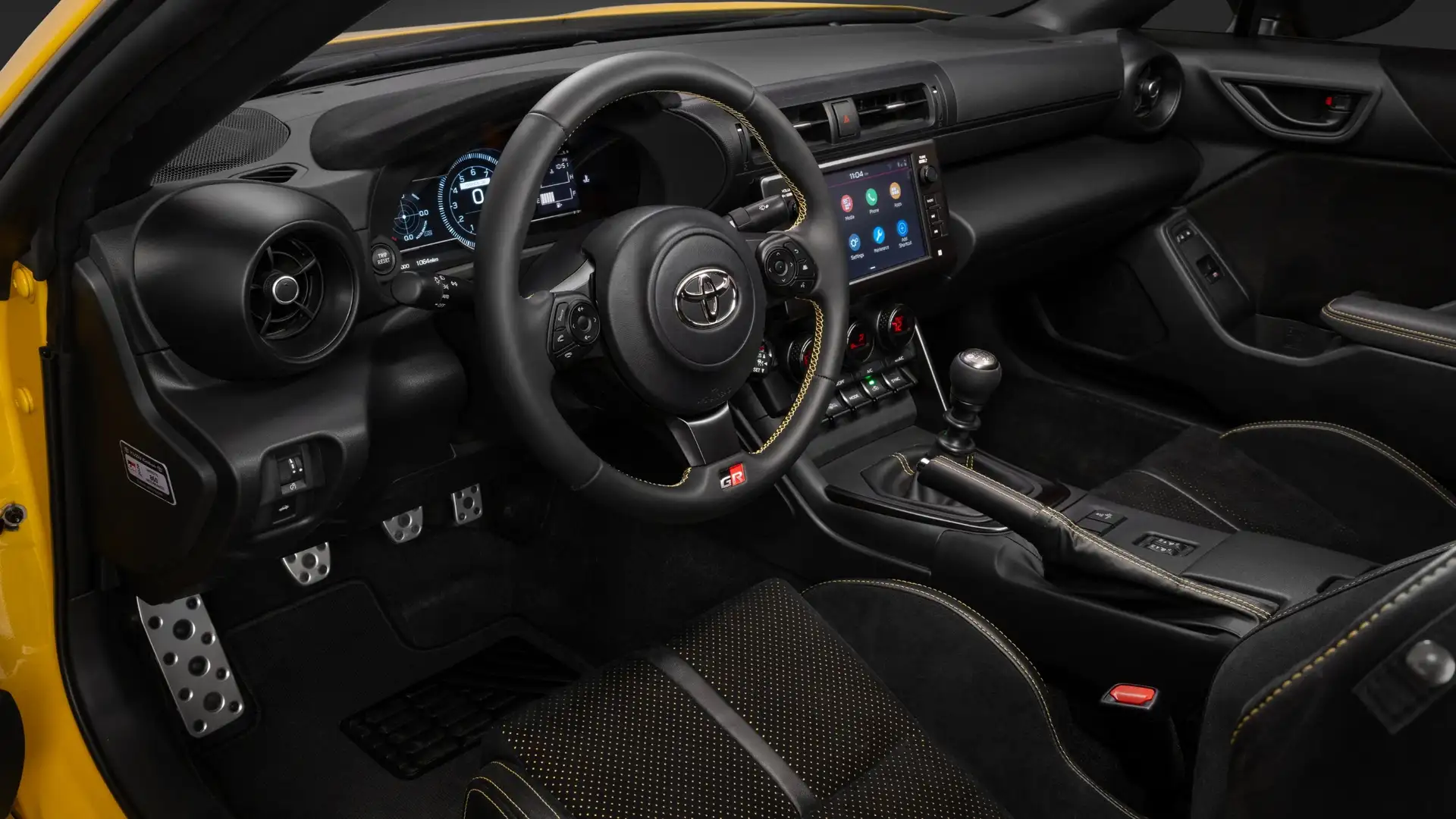 2026 Toyota GR86 infotainment and connectivity system featuring touchscreen display, smartphone integration, climate controls, and driver centered dashboard layout.