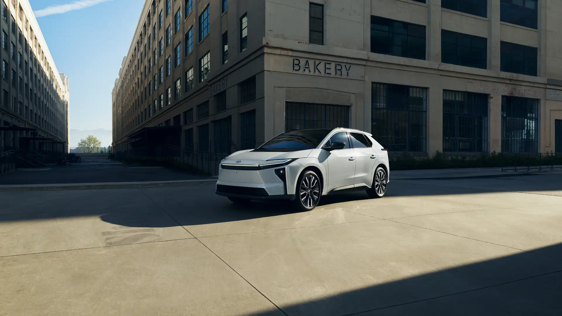 2026 Toyota bZ parked in an urban setting, highlighting futuristic electric SUV styling and clean exterior design near Hagerstown, MD.
