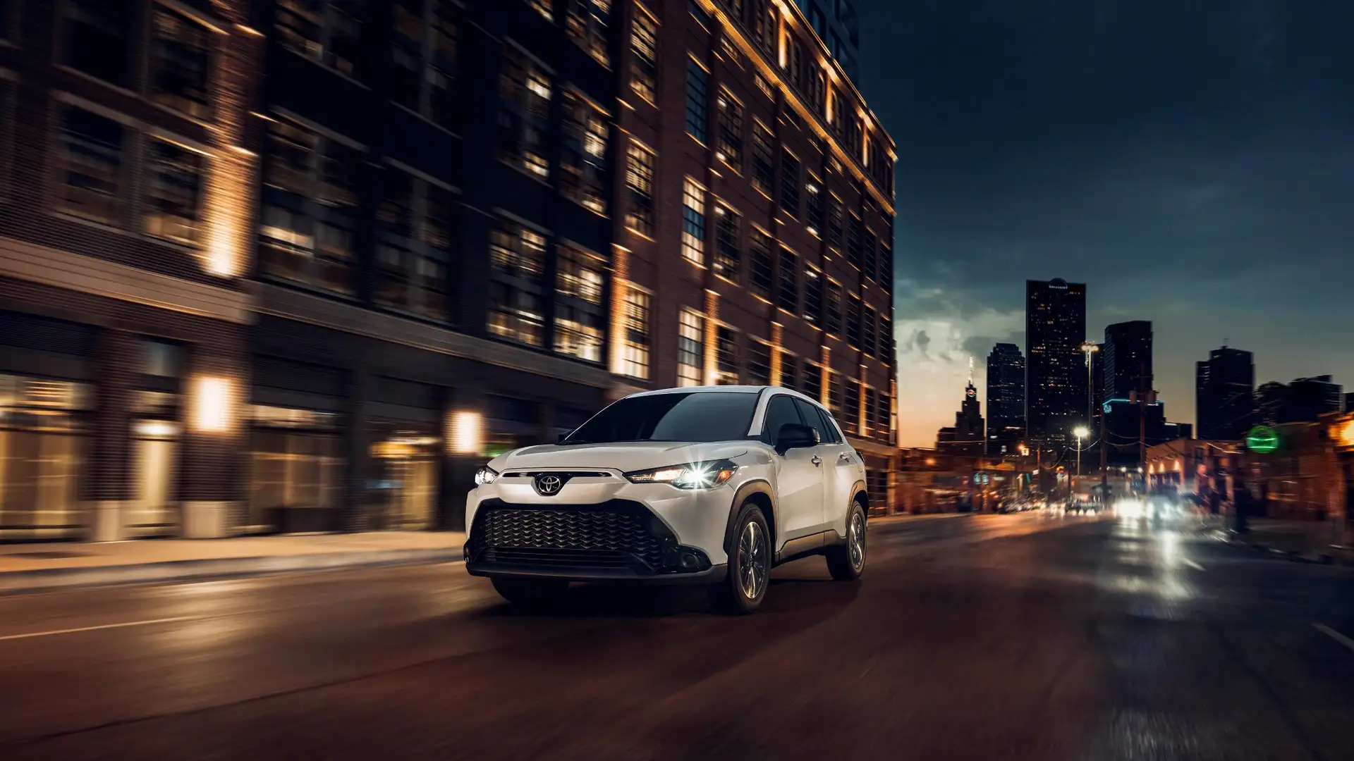 2025 Toyota Corolla Cross Hybrid parked in a wooded outdoor setting, showcasing rugged design and hybrid efficiency for Hagerstown adventure seekers