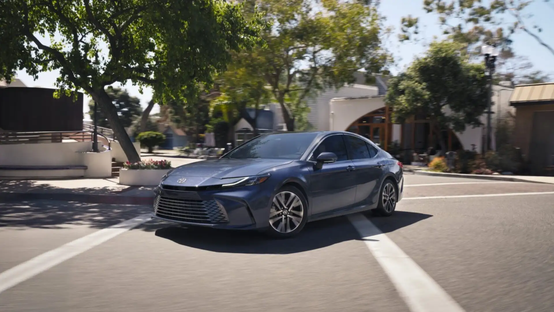 2026 Toyota Camry sedan driving through a city street, highlighting sleek design and advanced safety technology for Hagerstown commuters