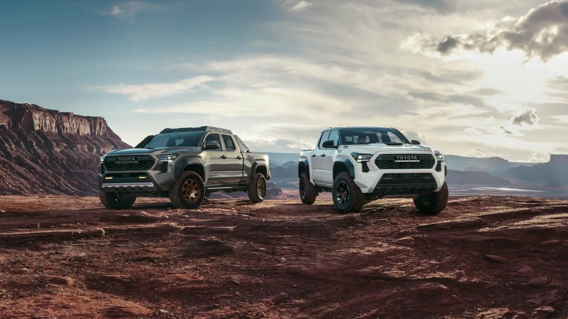 Two 2025 Toyota Tacoma trucks positioned on rocky terrain, highlighting towing strength and hauling capability for Hagerstown drivers.