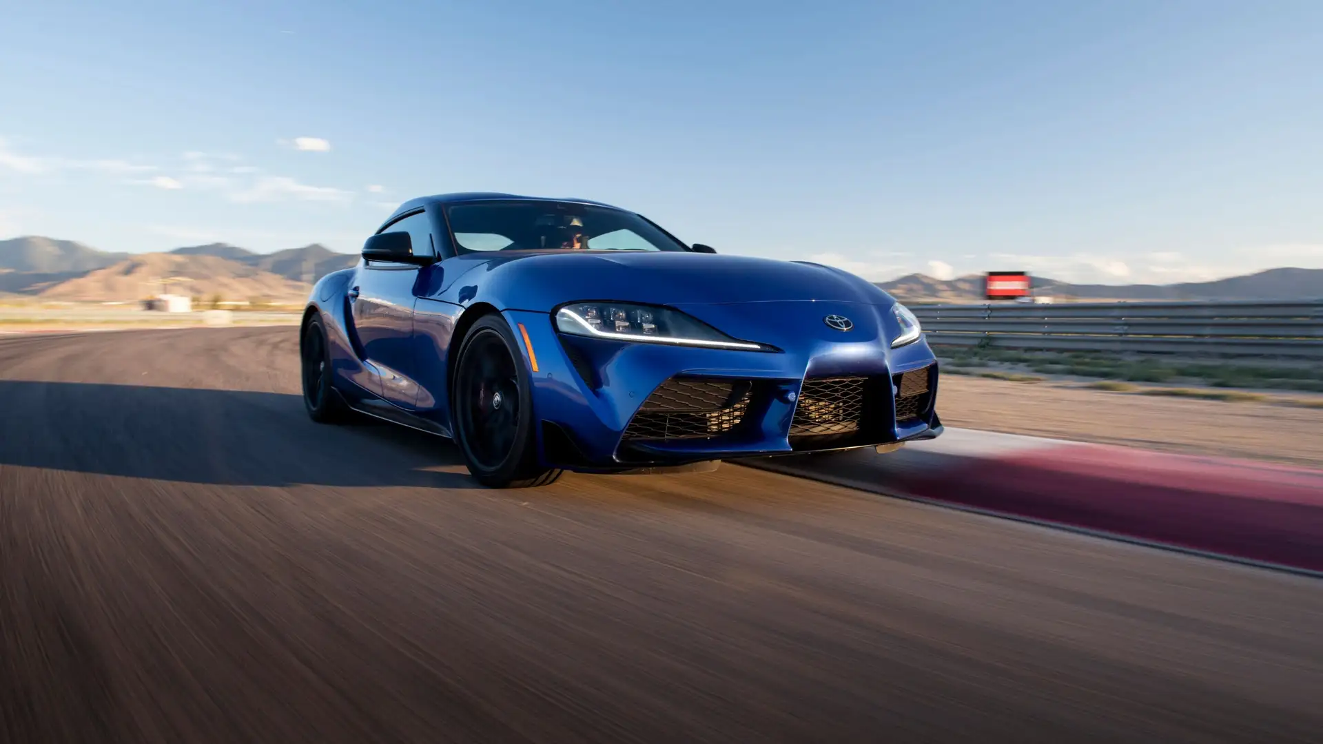 2026 Toyota GR Supra driving on a racetrack, featuring sporty performance and aggressive styling favored by young drivers in Greencastle, PA.