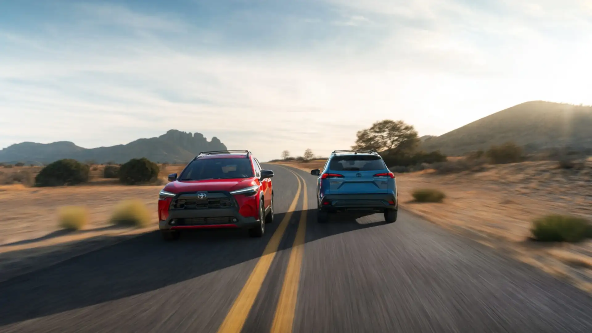 2026 Toyota Corolla Cross driving on an open road, highlighting compact SUV styling and family-friendly design for Hagerstown drivers comparing it to the Honda HR-V
