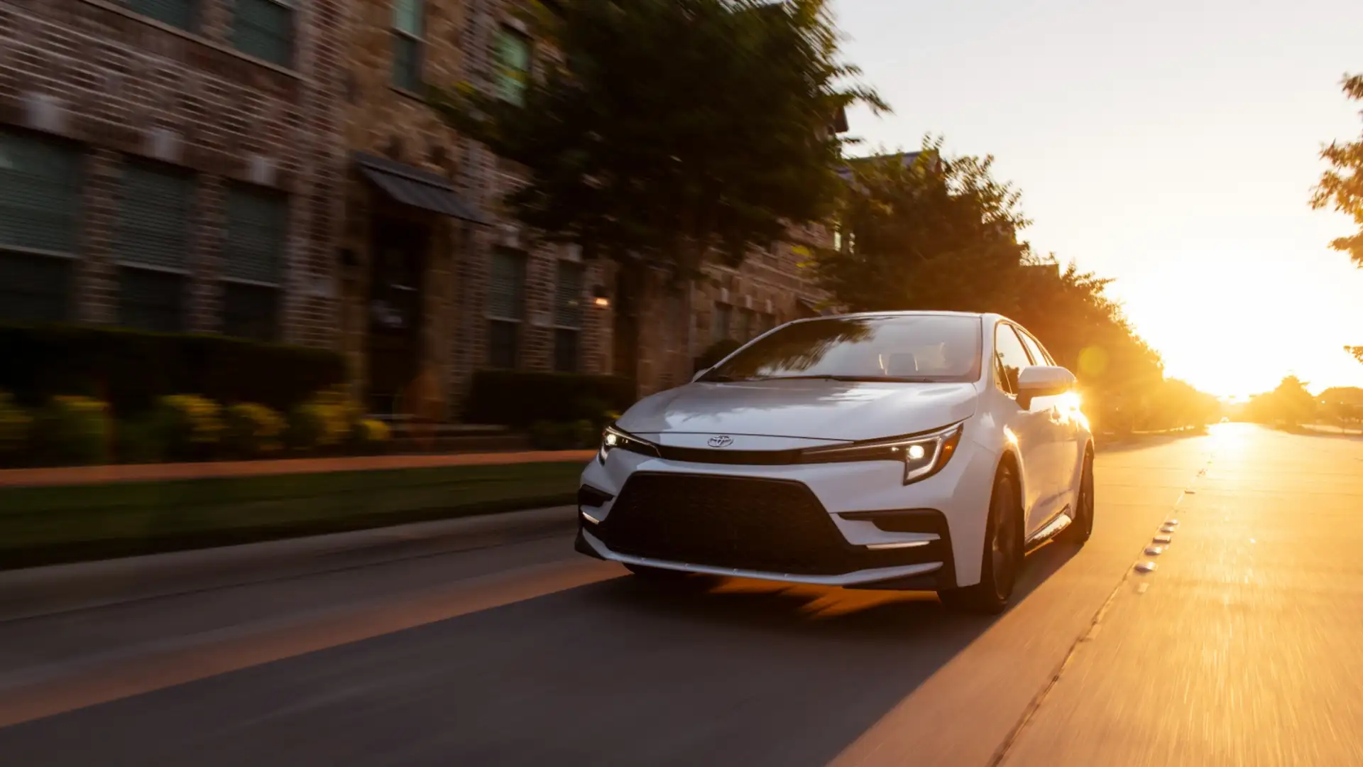 2025 Toyota Corolla sedan driving during sunset, emphasizing fuel efficiency and safe winter commuting for new drivers in Greencastle PA.