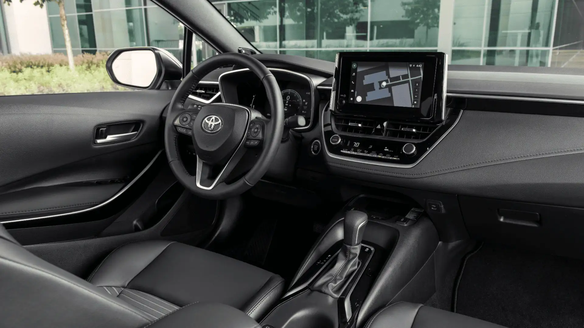 Interior of the 2026 Toyota Corolla displaying digital instrument cluster, touchscreen navigation system, and driver-focused dashboard layout.