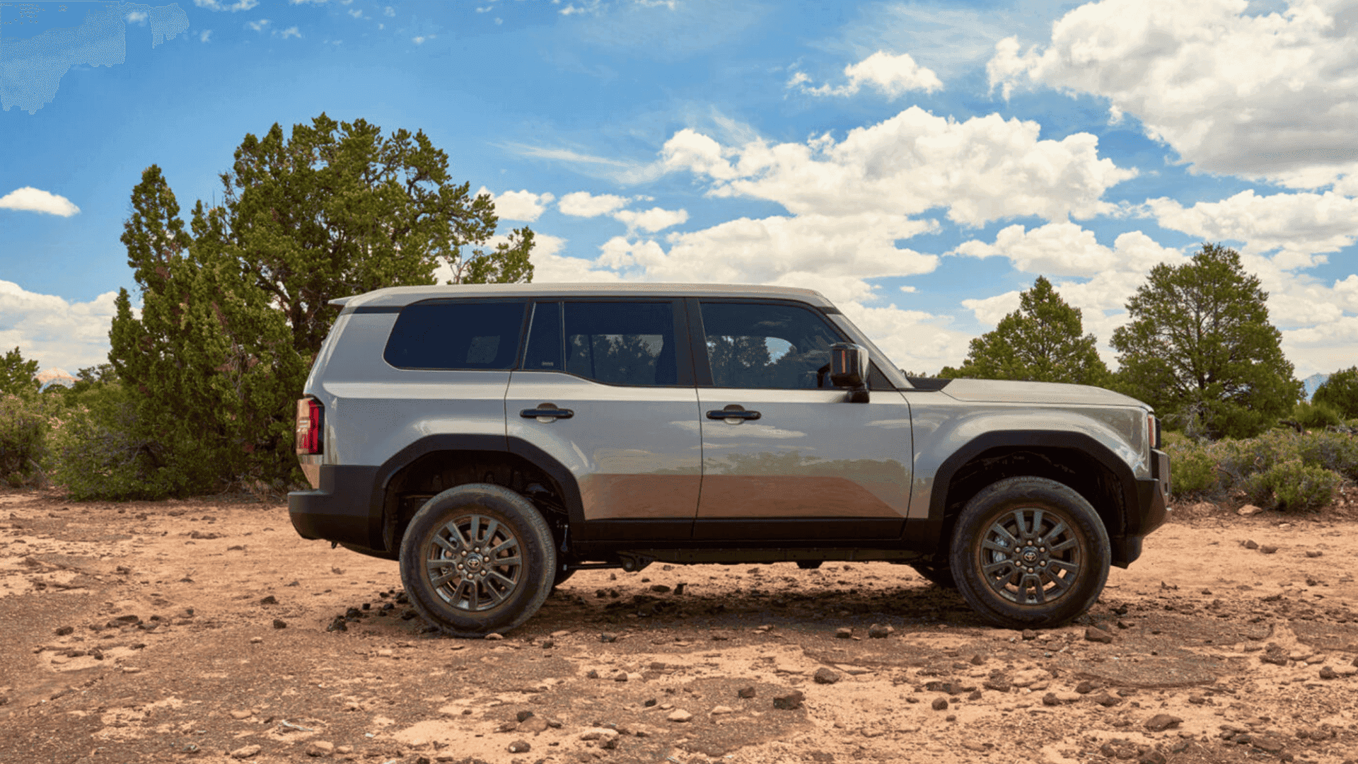 Side profile of a 2026 Toyota Land Cruiser parked on rugged terrain, highlighting off-road capability and durable SUV design near Hagerstown, MD.