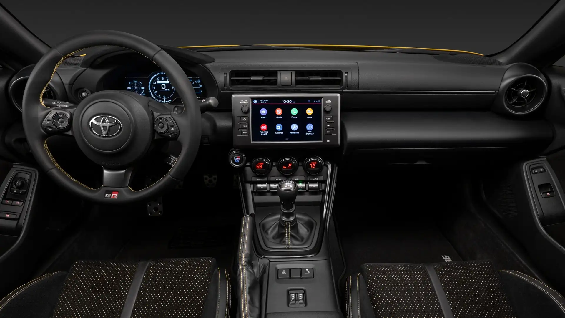 2026 Toyota GR86 cockpit view showing touchscreen infotainment with app interface, GR steering wheel, manual transmission, and sport gauges