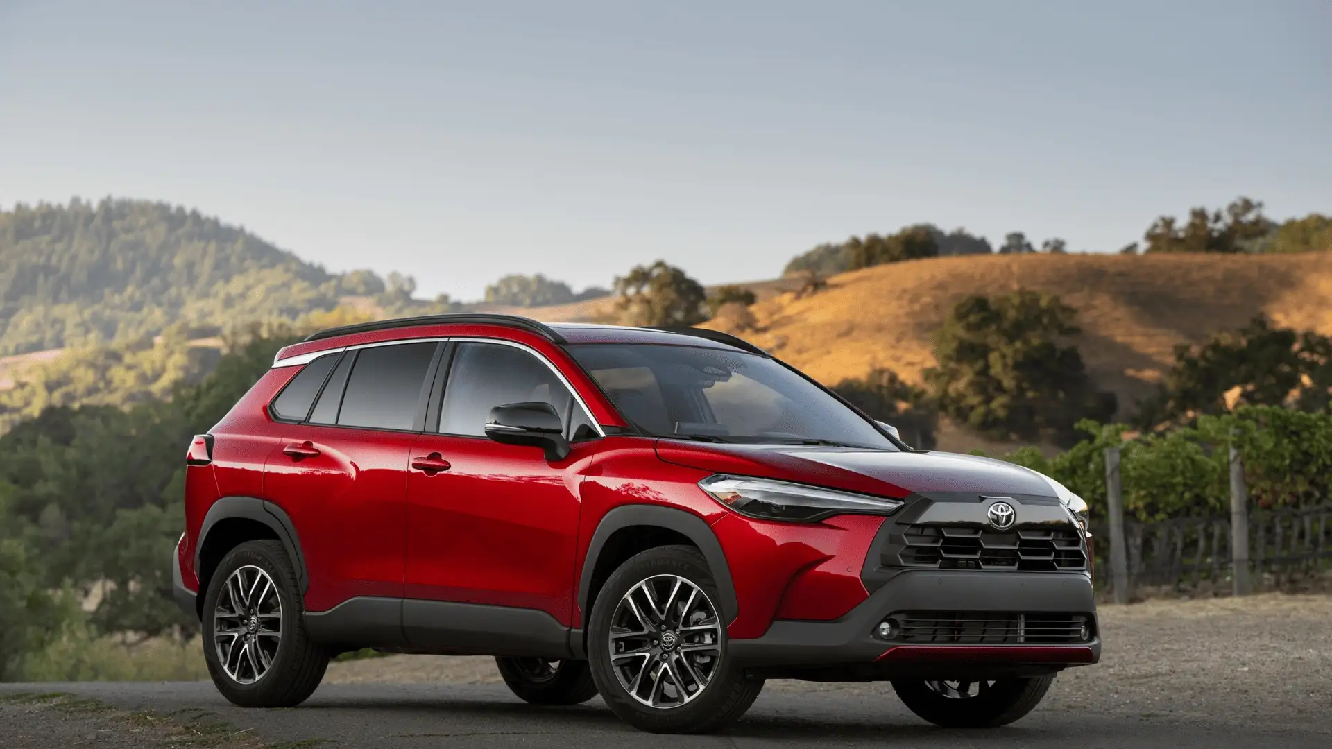 2026 Toyota Corolla Cross red SUV exterior parked near hills in Hagerstown MD