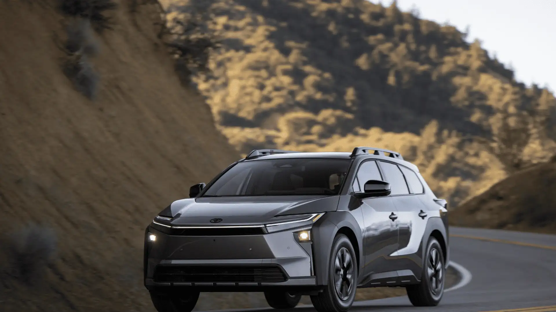 2026 Toyota bZ Woodland gray electric SUV front view on mountain road in Hagerstown MD