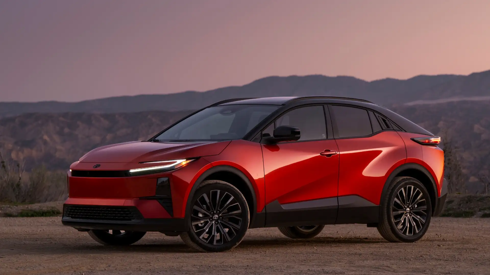 2026 Toyota C-HR electric SUV in red with black roof and black alloy wheels parked at desert overlook during sunset in Hagerstown MD