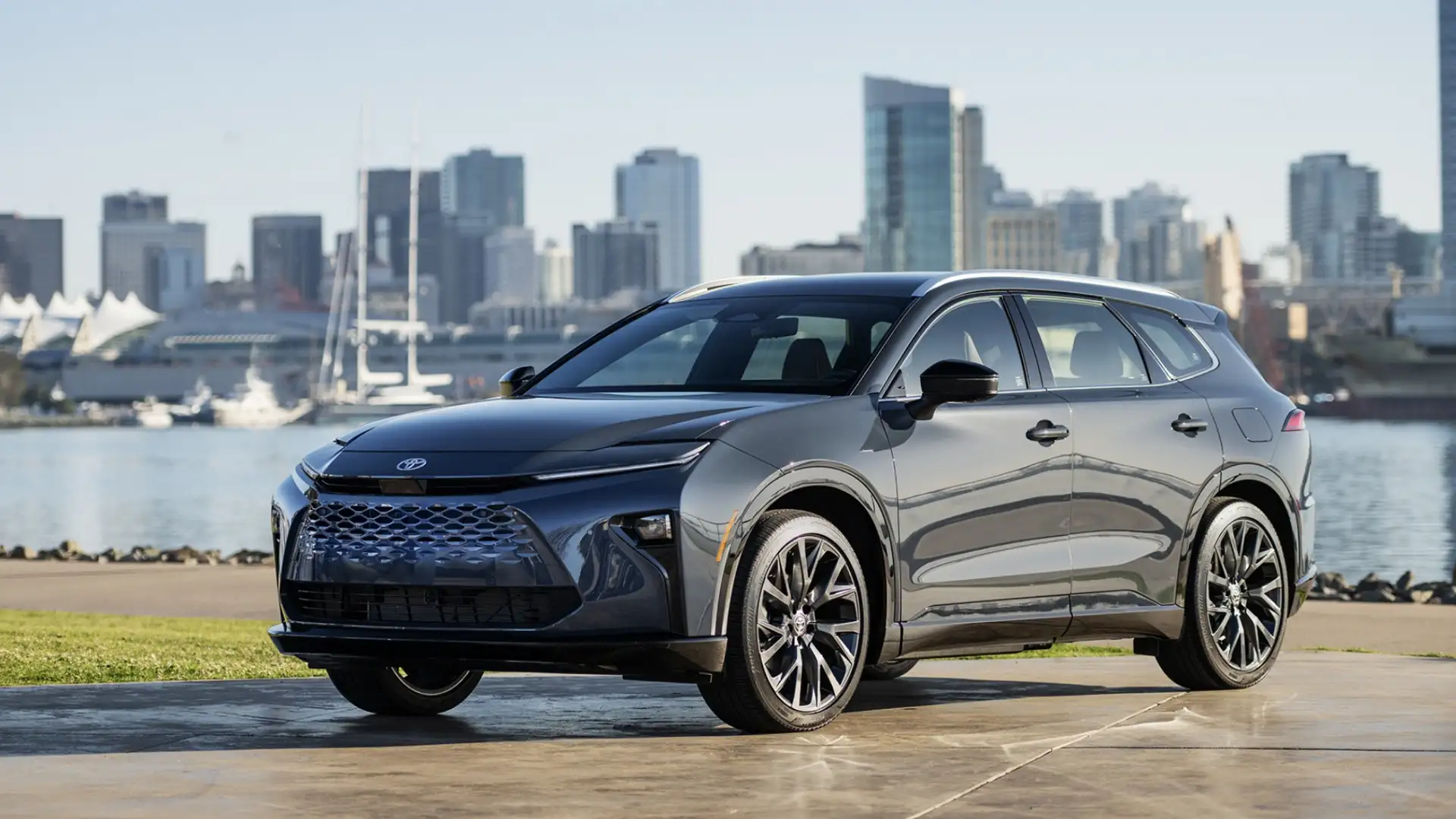 2026 Toyota Crown Signia two-tone SUV in dark gray with black roof and large alloy wheels parked at urban waterfront with city skyline in Hagerstown MD