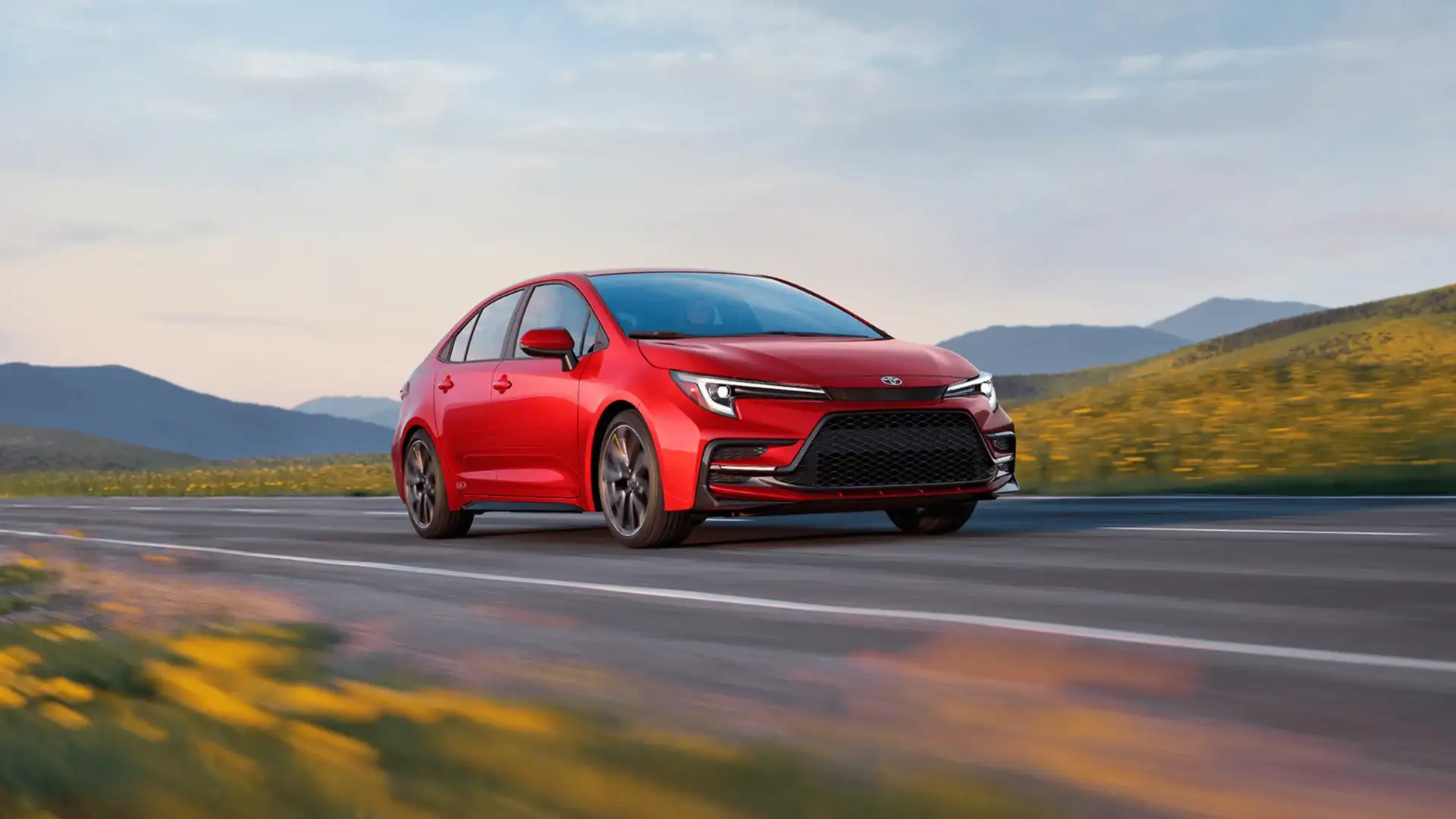 Red 2027 Toyota Corolla driving scenic road in Hagerstown MD