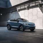 2025 Volvo C40 Recharge electric coupe SUV driving through tunnel in blue exterior finish