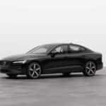2025 Volvo S60 luxury sedan in black shown in three-quarter front view with sporty alloy wheels