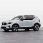 2025 Volvo XC40 compact SUV in light gray shown in three-quarter front view with bold grille design
