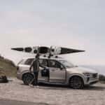 2025 Volvo XC90 luxury SUV parked outdoors with roof-mounted kayak and premium wheel design